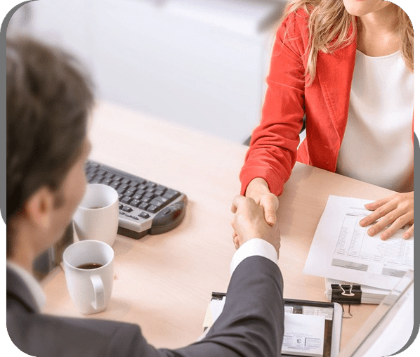 Two professionals shaking hands in a business meeting.